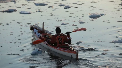 Two mans moving on kayaks moving in the middle of Arctic Ocean, Greenland Video stock 100872315