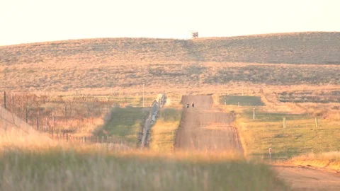 Two marathon runners training on a hilly dirt road Stock Footage 124217566