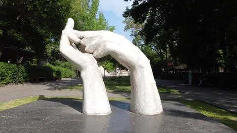 Two marble hands statue monument in downtown Yerevan gently touching each other Stock Photos