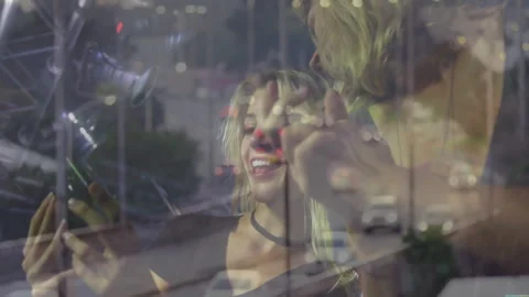 Two marketers using smartphone selfie technology in club with bokeh lights and Stock Footage 307652249