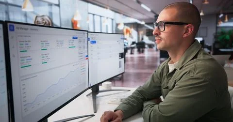 Two Marketing Analysts Work Together On Campaign Data Using Computers. Stock Photos