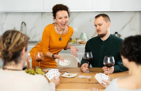 Two married couples playing card game poker Stock Photos