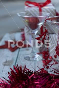 Two martini glasses surrounded by new year gifts Stock Photos