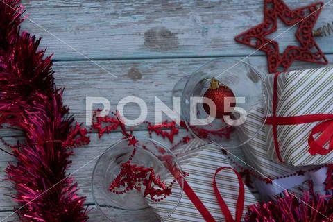 Two martini glasses surrounded by new year gifts Stock Photos
