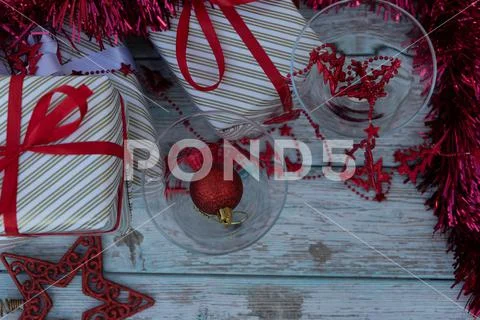 Two martini glasses surrounded by new year gifts Stock Photos