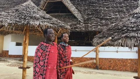 Two Masai people dances national dance at sunset and bids farewell to the sun.4K Stock Footage