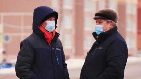 Two masked men are talking and waiting for a taxi. Stock Footage 149032508