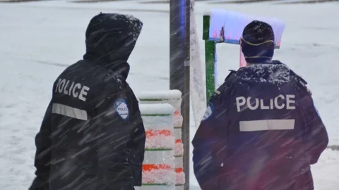 Two masked officers chatting during COVID-19 pandemic Stock Footage 127055804