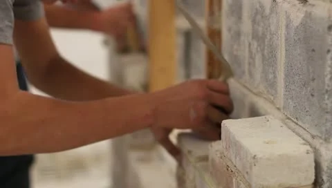 Two masons laying brick on wall Stock-Footage 10704032