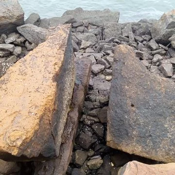 Two massive angular boulders separated by narrow gap crushed gravel 写真素材