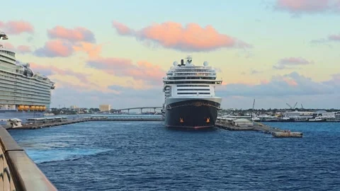 Two massive cruise ships docked in a harbor during sunset Stock Footage 341908749