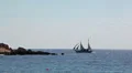 Two-masted sail ship sailing on the Mediterranean sea over rocky island, Cyprus HD Footage