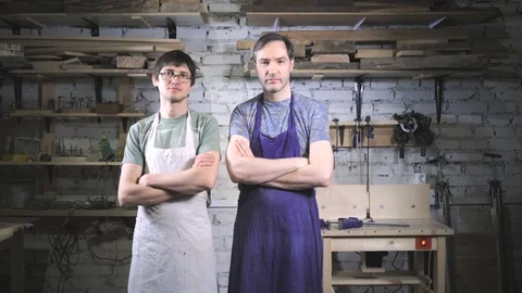 Two master carpenter in an apron in his workshop. Small business Stock Footage 102567481