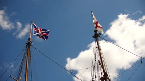 Two masts of a tall ship or sailing ship flying British maritime flags Stock Footage 151566551