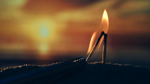 Two matches burn in the setting sun like a couple kissing Stock Footage 195400453