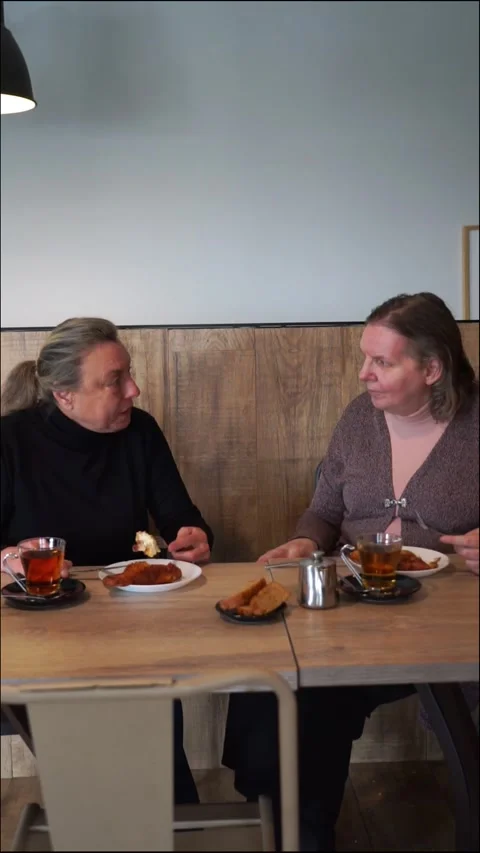 Two mature women chatting while eating typical torrijas for Holy Week in Sp.. Stock Footage 263219009