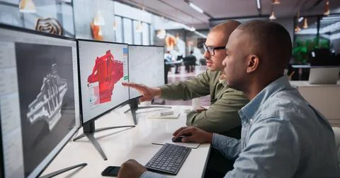 Two Mechanical Engineers Are Working Together On 3D CAD Designs At Office. Stock Photos