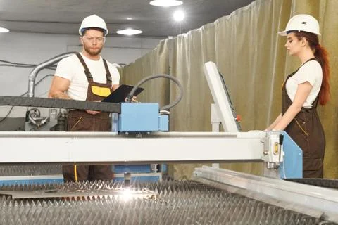 Two mechanics controlling process of plasma cutting Stock Photos