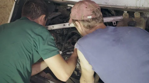 Two mechanics repair car engine Video stock 110862754