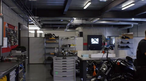 Two mechanics runningTwo mechanics running diagnostics on a bespoke motorbike Video stock 63027226