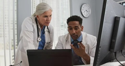Two medical doctors using technology inside office Stock Footage 98262999