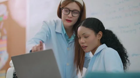 Two Medical Students Preparing an Anatomy Lesson with a Laptop in a Classroom 스톡 동영상 339406523