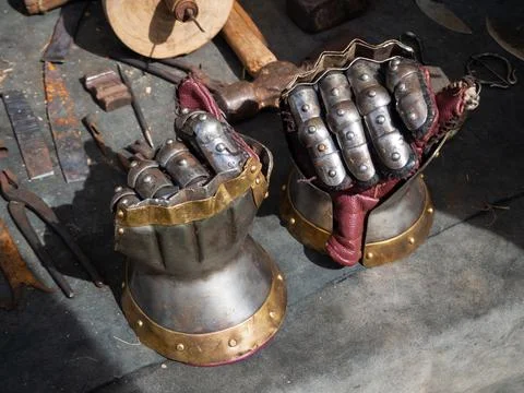 Two medieval armor gloves on the table Stock Photos