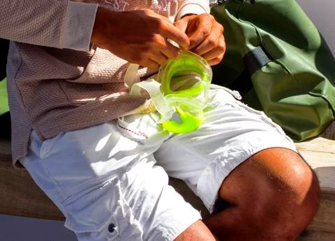 Two men aboard the ship prepare a diving mask for immersion Stock Photos
