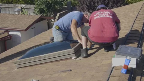Two Men Adjusting a Large Skylight Glass Window on a Rooftop Stock Footage 212417732