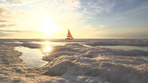 Two men and a catamaran in front of the sunlight on the ice floe, North Pole Video stock 104909502