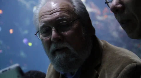 Two men in aquarium laughing using Ipad Stock Footage 36152733