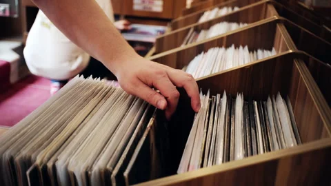 Two men are browsing vintage vinyl records at a store. Looking for rare Stock Footage 244220032