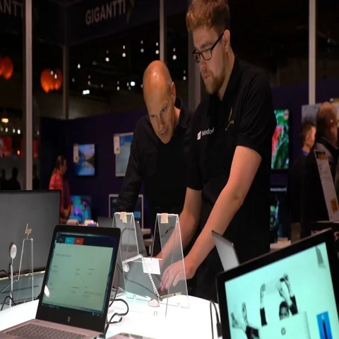 Two men are considering an laptop with touch screen in an electronics store. Stock Footage 69506218