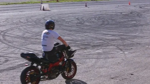 Two men are doing a show stunt performance on motorcycles Stock Footage 119873194