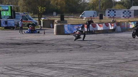 Two men are doing a show stunt performance on motorcycles Stock Footage 119873628