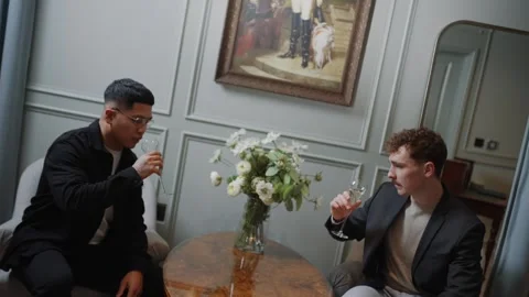 Two men are drinking wine and one of them is wearing glasses Stock Footage 295996712