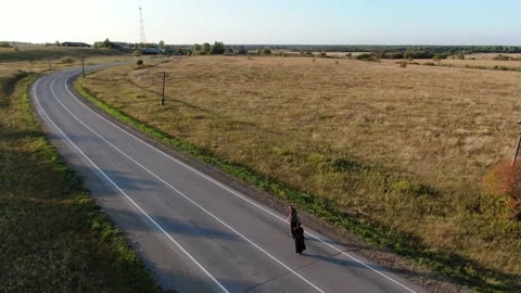 Two men are driving along the road on unicycles Stock Footage 160762696