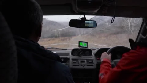 Two men are driving fast in a car off-road. The view from inside. Stock Footage 266887115