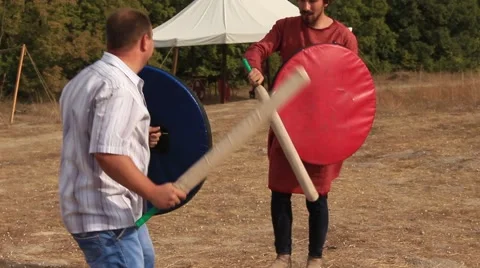 Two Men are Fighting with the Truncheons and Shields at the Historical Festival Stock Footage 61369259