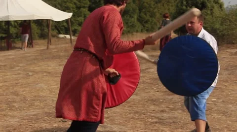 Two Men are Fighting with the Truncheons and Shields at the Historical Festival Stock Footage 61369271