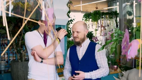 Two men are listening to something on the phone, both with beards, one of them Stock-Footage 153729799