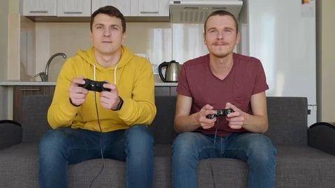 Two men are playing a video game against each other Stock Footage 107651999