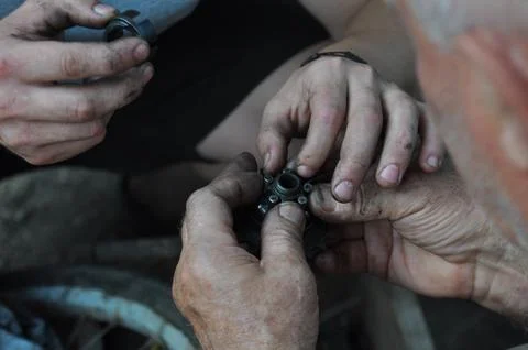 Two men are replacing worn parts on their favorite bicycle Fotos Stock