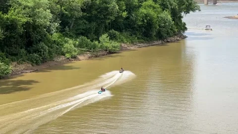 Two men are riding water scooters along the river. Top view from the bridge Stock Footage 201894006