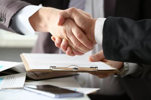 Two men are shaking hands in office Foto stock