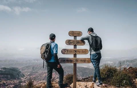 Two men are standing on the peak of ISK WAKLIM 1159 in Morocco. Stock Photos