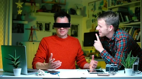 Two men are talking at the office table. The guy is doing finger interviews. Stock Footage 120530576