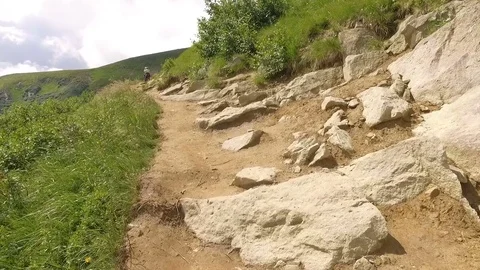 Two men are on the trail over the cliff of the mountain. Ukraine, mount Hoverla Stock Footage 73542890