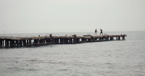 Two men are training boxing on an old pier by the sea. Stock Footage 260525672