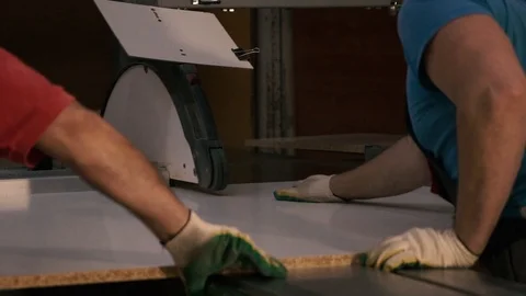 Two men are working at the machine. Processing of wooden structures for the cabi Stock Footage 125426937